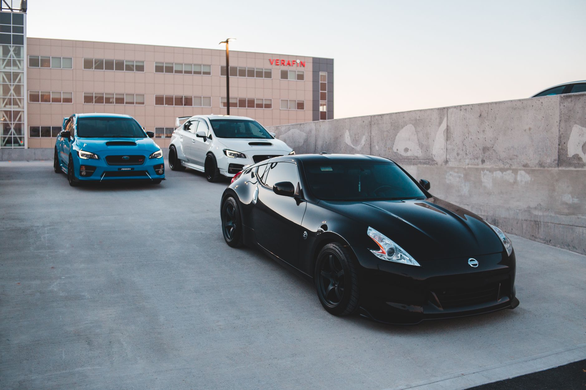 Sports cars parked on concrete road near wall against non residential building and clear sky at sunset — What is Stated Value